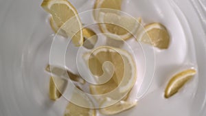 Sliced fresh lemons rain on yogurt - High-angle shot