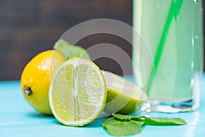 Sliced fresh lime with glass of lemon juice