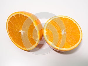 Sliced fresh orange cut in half on white background, overhead view