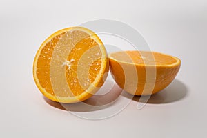 Sliced fresh orange cut in half on white background