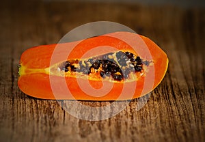 Sliced fresh papaya on wooden background