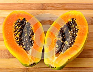 Sliced fresh papaya on wooden background