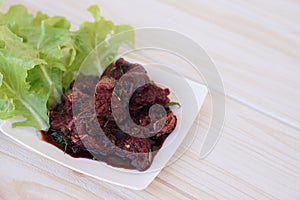 Sliced fresh raw beef to small pieces, mixed with Thai herbs ingredients and blood,