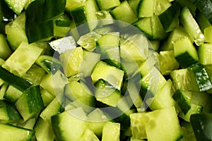 Sliced fresh raw cucumber, cubes, heap, background