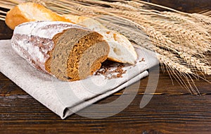 Sliced fresh rye bread and crusty baguette