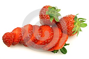 Sliced fresh strawberry and two whole ones