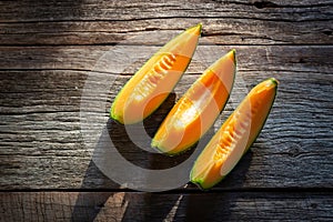 Sliced fresh sweet melon on wooden board. Orang texture and juic