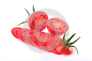 Sliced fresh tomatoes with green leaves isolated on white background