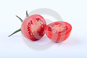 Sliced fresh tomatoes with green leaves on white background