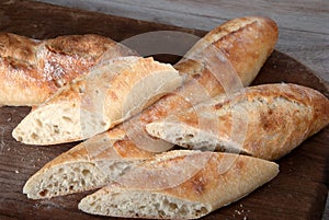 Sliced Freshly Baked Baguette on Wooden Board.