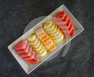 Sliced fruit on dish, pineapple and watermalon and melon