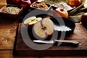 Sliced gala apple on wood cutting board with ingredients