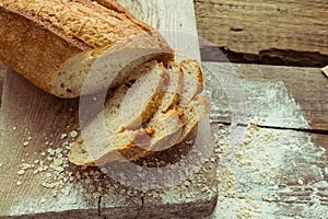 Sliced gluten free bread on wooden table.
