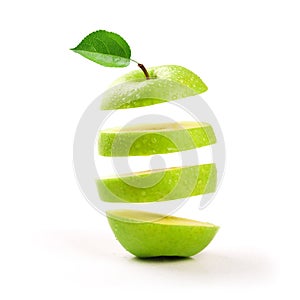 Sliced green apple levitating on white