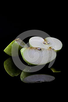 Sliced green apple from side with reflection vertical