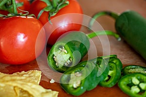 Sliced green jalapeÃ±o pepper with bright red tomato