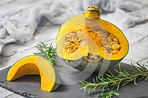 Sliced green sombra pumpkin on gray background photo