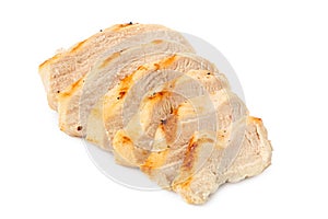Sliced grilled chicken breast with grill marks, ground black pepper and salt isolated on white