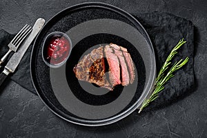 Sliced grilled filet Mignon steak. Beef tenderloin. Black background. Top view