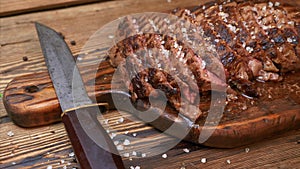 Sliced Grilled Meat Beef Steak Ribeye with Spices on Rustic Wooden Cutting Board