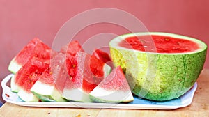 Sliced and a half watermelon fruit in a white bowl.