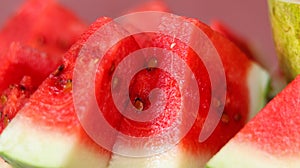 Sliced and a half watermelon fruit in a white bowl.