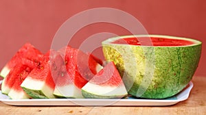 Sliced and a half watermelon fruit in a white bowl.