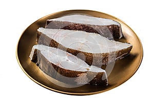 Sliced halibut fish, raw steaks on plate with thyme. Isolated on white background. Top view.
