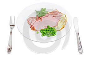 Sliced ham and smoked cheese, green peas, fork and knife