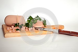 Sliced ham on wooden board