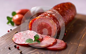 A sliced ham on a wooden cutting board