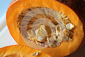 Sliced hokkaido pumpkin o a white chopping boardn