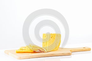 Sliced holland cheese on a cutting board