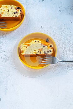 Sliced homemade Apricot Blueberry pound cake on yellow plate