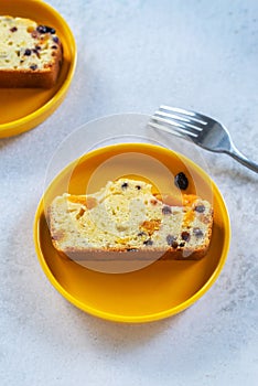 Sliced homemade Apricot Blueberry pound cake on yellow plate