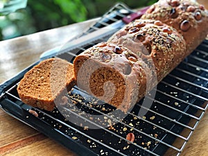 Sliced of homemade bread on the black tray with natural light. Bakery from home.