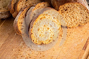 Sliced homemade bread on the wooden cutting board. Selective focus. Shallow depth of field