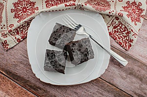 Sliced homemade brownies on white plate. Served on rectangle white plate. Favorite chocolate dessert for chocolate lover. Sweet