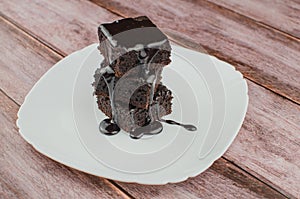 Sliced homemade brownies on white plate. Served on rectangle white plate. Favorite chocolate dessert for chocolate lover. Sweet