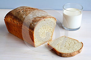 Sliced homemade cornbread with a glass of milk, br