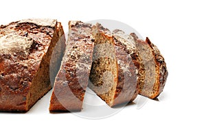 Sliced homemade rye bread with seeds isolated on white background