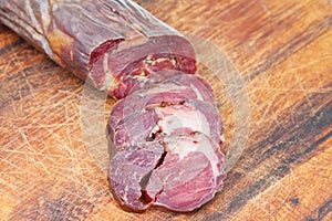 Sliced horse meat sausage kazi close up on board