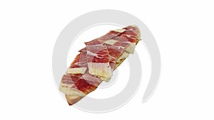 Sliced Iberian ham (jamón serrano) on a slice of bread, rotating, isolated on white background.