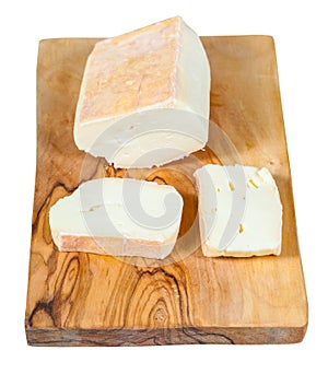 Sliced italian Taleggio cheese on board isolated