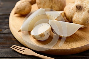 Sliced jicama or yam on chopping wooden board