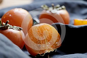 Sliced kaki on basket.Ripe orange persimmon fruit.