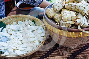 Sliced ketupat in big bamboo bowl in traditional food market in central java