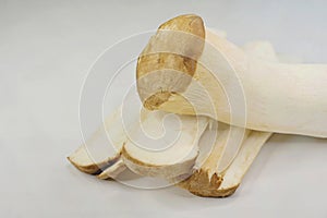 Sliced King Oyster Mushroom stems and whole stalk, isolated on white