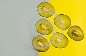 Sliced kiwi isolated on yellow-blue background. Copyspace for text