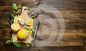 Sliced lemon on the board with leaves.